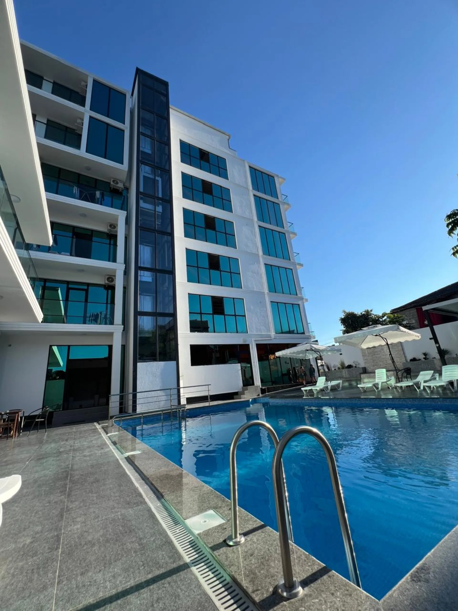 Hotel Chipo pool with ladder and building